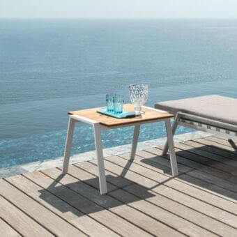 Distinguished Talenti Cottage table crafted with iroko wood tabletop and a matte white aluminum structure