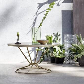 Elegant Roberti Rattan Gravity coffee table with round aluminum top and striking stainless steel base in beige-tan finish