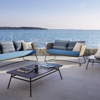 Elegant Roberti Rattan Portofino sofa with blue textile cushions and woven sides crafted in powder-coated aluminum with Nautic Rope