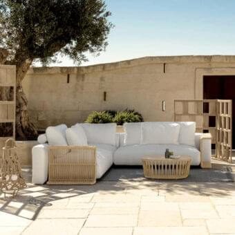 Distinguished Talenti Cliff Déco sectional with bright white textile upholstery and woven nautical rope detailing on a fully aluminum frame