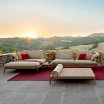 Sophisticated Talenti Cruise sectional with smoke teak wood frame and weather-resistant beige fabric cushions accented with warm red and peach hues