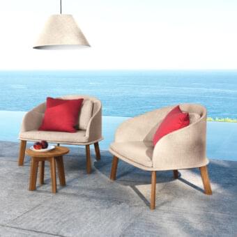 Distinguished Talenti Cleo lounge chair with a high-end wood structure and neutral beige textured fabric complemented by vibrant red cushions