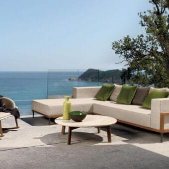Distinguished Talenti Cleo coffee table with natural stone patterns and angled teak wood legs crafted in Italy