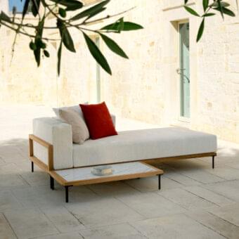 Sophisticated Talenti Cleo lounger with geometric teak frame and vibrant red cushions offering a minimalist aesthetic