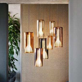 Distinguished Penta Lit suspension lamp exhibiting gradient coloration with mirroring glass exterior and striped sandblasted glass interior