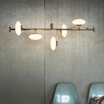 Distinguished Penta Mamì suspension lamp with five opaque white blown glass shades and brushed bronze metal structure