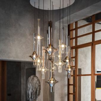 Elegant Penta Wonder suspension lamp with cascading transparent borosilicate glass shades and polished silver-grey matt varnished metal framework