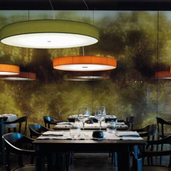 Exceptional Modo Luce Discovolante suspension lamp with an orange textile shade and white internal diffuser embodying minimalist design