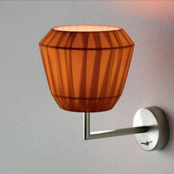 Captivating Modo Luce Loto wall lamp with a warm orange pleated fabric shade and brushed metal arm