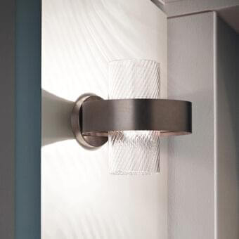 Elegant Vistosi Armonia wall lamp with a metal ring frame and vertically ribbed translucent glass diffuser crafted in dark bronze or charcoal gray with a satin finish