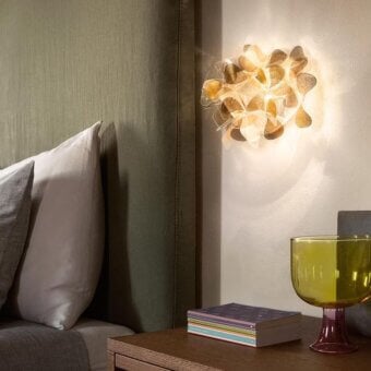 Elegant Slamp Clizia Wall Lamp with Cristalflex petals diffusing warm light amber and off-white tones for a modern organic form