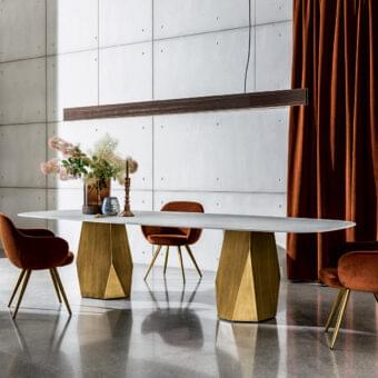 Distinguished Sovet Italia Deod table with a light gray ceramic laminated oval top and golden lacquered geometric metal bases