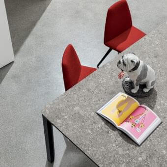 Distinguished Sovet Italia Kodo table with speckled gray ceramic and sleek matte black aluminum structure