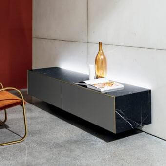 Distinguished Sovet Italia Magda sideboard with smooth ceramic structure and black marbled finish accented by gold-colored brass profiles