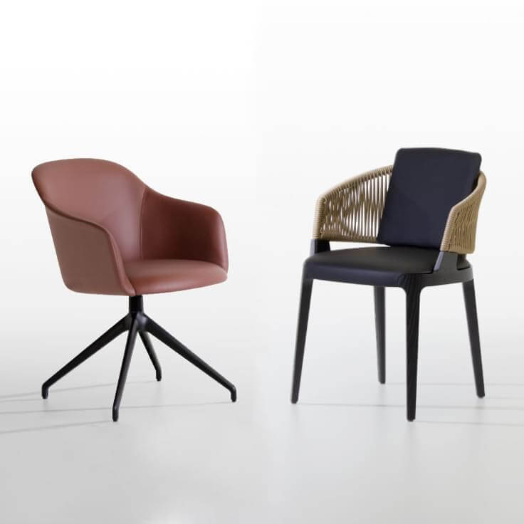 Terracotta leather swivel chair with black star base and black molded plastic dining chair with woven cord arms, studio shot.