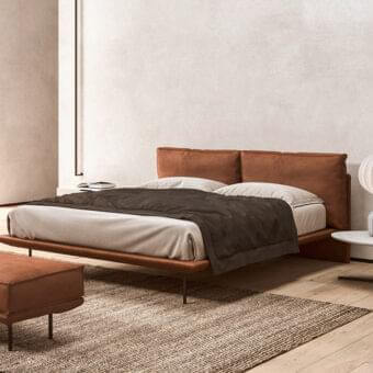 Superior Presotto Cali bed with reddish-brown upholstered wood frame and slim dark metal legs