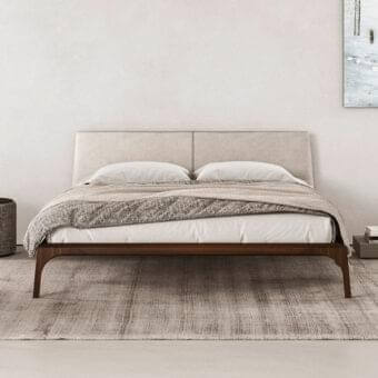 Elegant Presotto Relevè bed with dynamic lines crafted in medium-brown wood and neutral leather or Tecnopelle headboard with satin finish