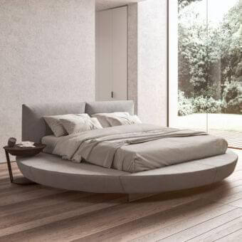 Elegant Presotto Zero bed with light gray leather upholstery and stitched detailing along a padded base