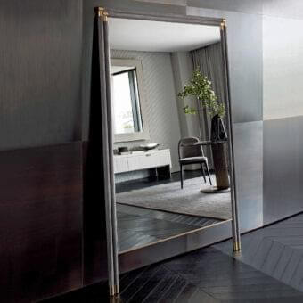 Distinguished Rugiano Boheme mirror with tall rectangular form, dark-toned wood and subtly textured gray textile with golden metal accents