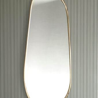 Exclusive Rugiano Montecarlo mirror with elongated organic silhouette in refined bronze and smooth gold-toned finish
