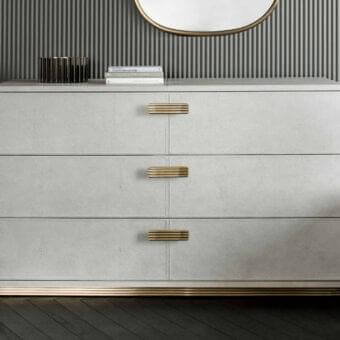 Exclusive Rugiano Club dresser crafted in light gray leather with brushed brass handles and matching base band