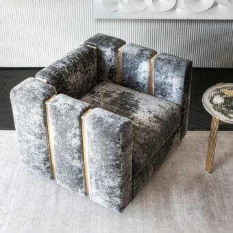 Sophisticated Rugiano Club lounge chair in muted gray crushed velvet with innovative brushed brass drawn tubes