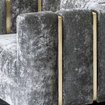Innovative Rugiano Club lounge chair in dark gray textile with brushed brass vertical accents and drawn tube structure