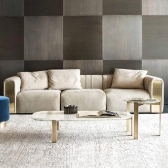 Superior Rugiano Luz sofa with neutral beige fabric upholstery and refined brushed brass detailing on armrests