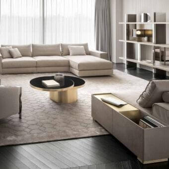 Elegant Rugiano Nautilus sectional upholstered in muted beige textile with smooth matte accents of brushed brass metal