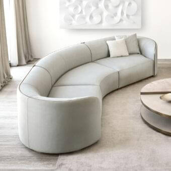 Elegant Rugiano Pierre sectional with light neutral gray textile upholstery and brushed gold-tone trim detailing a minimalist finish