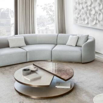 Distinctive Rugiano Pierre sectional with curved modular form upholstered in light muted gray textile and recessed bronze metal base