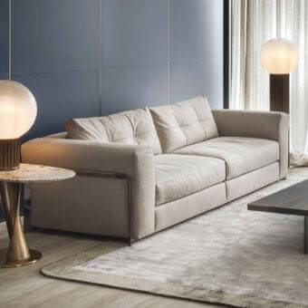 Distinguished Rugiano Arthur sofa upholstered in smooth matte beige leather with striking black chrome metal armrests