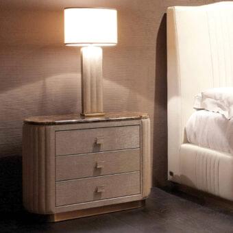 Elegant Rugiano Bach nightstand with curved structure, three leather-covered drawers and refined marble top in beige-grey tones