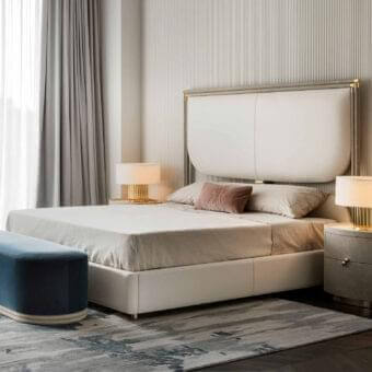 Sophisticated Rugiano Boheme bed with neutral beige upholstery and refined metal detailing offering a matte finish