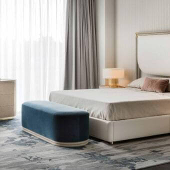 Sophisticated Rugiano Boheme bed with light beige textile upholstery and smooth light brown leather framing with bronze metal details