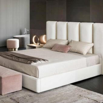 Innovative Rugiano Club bed with brushed brass tubes against white upholstered leather or fabric and smooth finish
