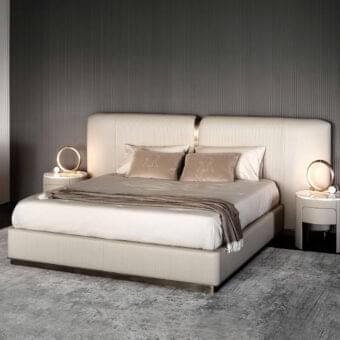 Exceptional Rugiano Vogue bed with neutral beige fabric upholstery and polished metal accents displaying baguette embroidery