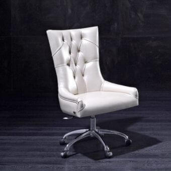 High-backed chair with button-tufted light upholstery and a five-point metallic base on a dark textured background