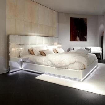Superior Rugiano Gemma bed with fully leather-covered frame and integrated lighting in a glossy white finish