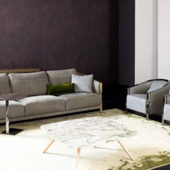Elegant Rugiano Paris sofa upholstered in light gray textile with quilted detailing and glossy metal frame