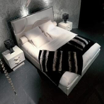 Sophisticated Rugiano Riflesso bed with a fabric or leather frame and stitched headboard in bronze or steel detailing with a glossy finish