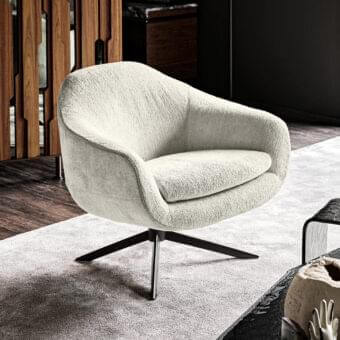 Distinguished Arketipo Bond lounge chair with textured bouclé-like fabric upholstery and dark metal swivel base