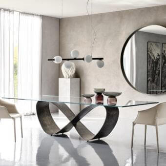 Innovative Cattelan Italia Butterfly table with a dark matte lacquered steel base and transparent glass top