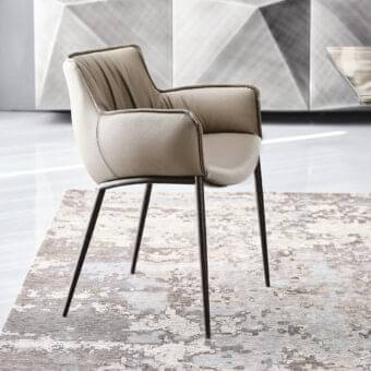 Distinguished Cattelan Italia Rhonda armchair with neutral beige fabric and embossed lacquered steel base appearing satin-finished