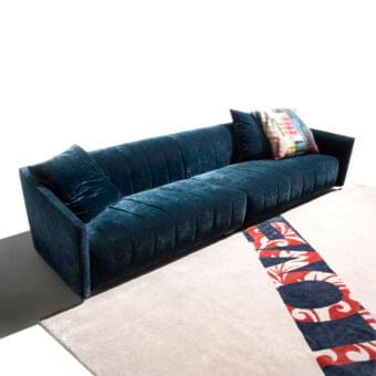 Distinguished Erba Belladonna sofa with deep blue velvet upholstery and refined quilting detailing