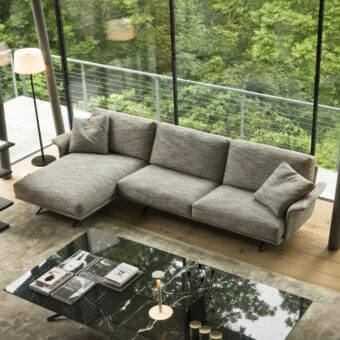 Distinguished Verzelloni Nilson sectional with textured matte gray textile upholstery and squared cushions presenting a minimalist aesthetic