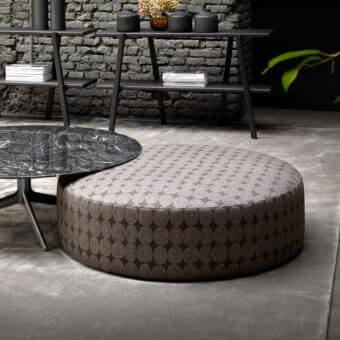 Stylish Verzelloni Planet ottoman with brown fabric upholstery and lighter tan concentric circles detailing