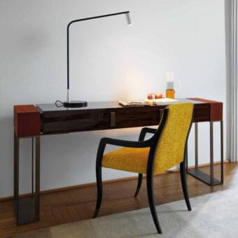 Distinguished OAK Montenapoleone desk crafted with glossy wood exhibiting grain and a satin metal base in dark reddish-brown tones