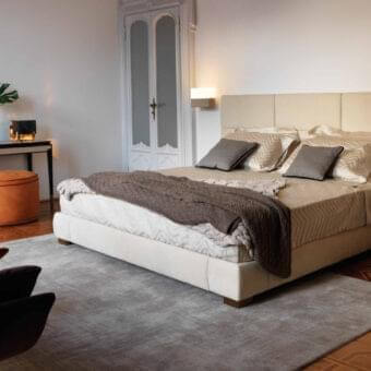 Elegant OAK Moscova bed with light beige textile upholstery and dark wood legs offers a harmonious aesthetic