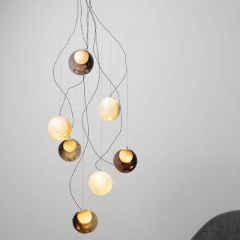Exceptional Bocci 28 sculptural lamp with hand-blown glass pendants in gold, amber, and pale yellow tones with slender black cables